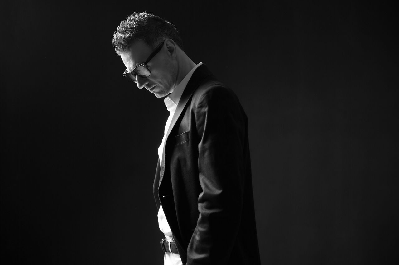 Black and white photo of a thoughtful businessman in glasses