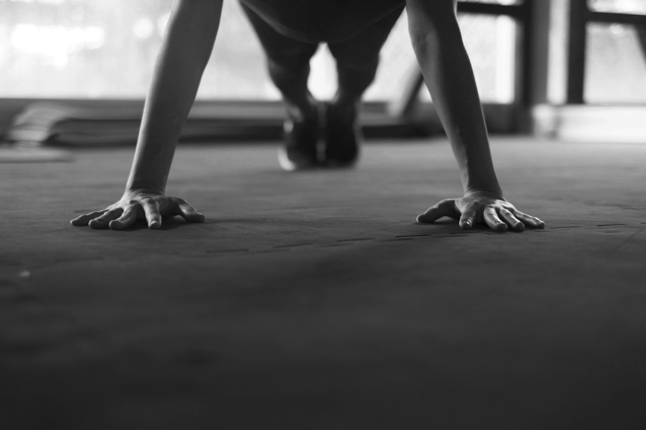 Closeup woman hand doing push ups exercise in a gym.